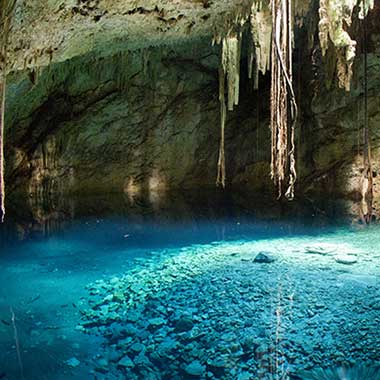 A turquoise pool of water shimmers in a cave. Groundwater sources often have nitrogen naturally occurring in the form of ammonia, nitrite and nitrate.