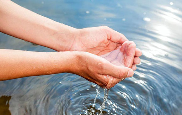 two hands cupping incoming/raw water