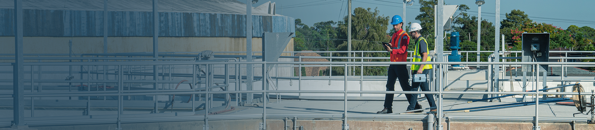 Hach Service Representative in blue shirt providing Hach Service to customer onsite at treatment plant