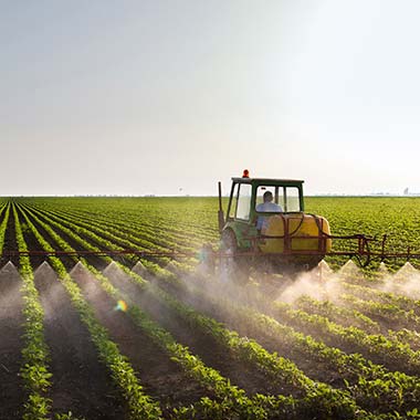 A farm tractor fertilizes crops introducing nitrogen in the form of ammonia.